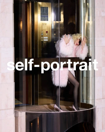 Woman in pink fluffy coat and high heels stepping inside a modern glass elevator