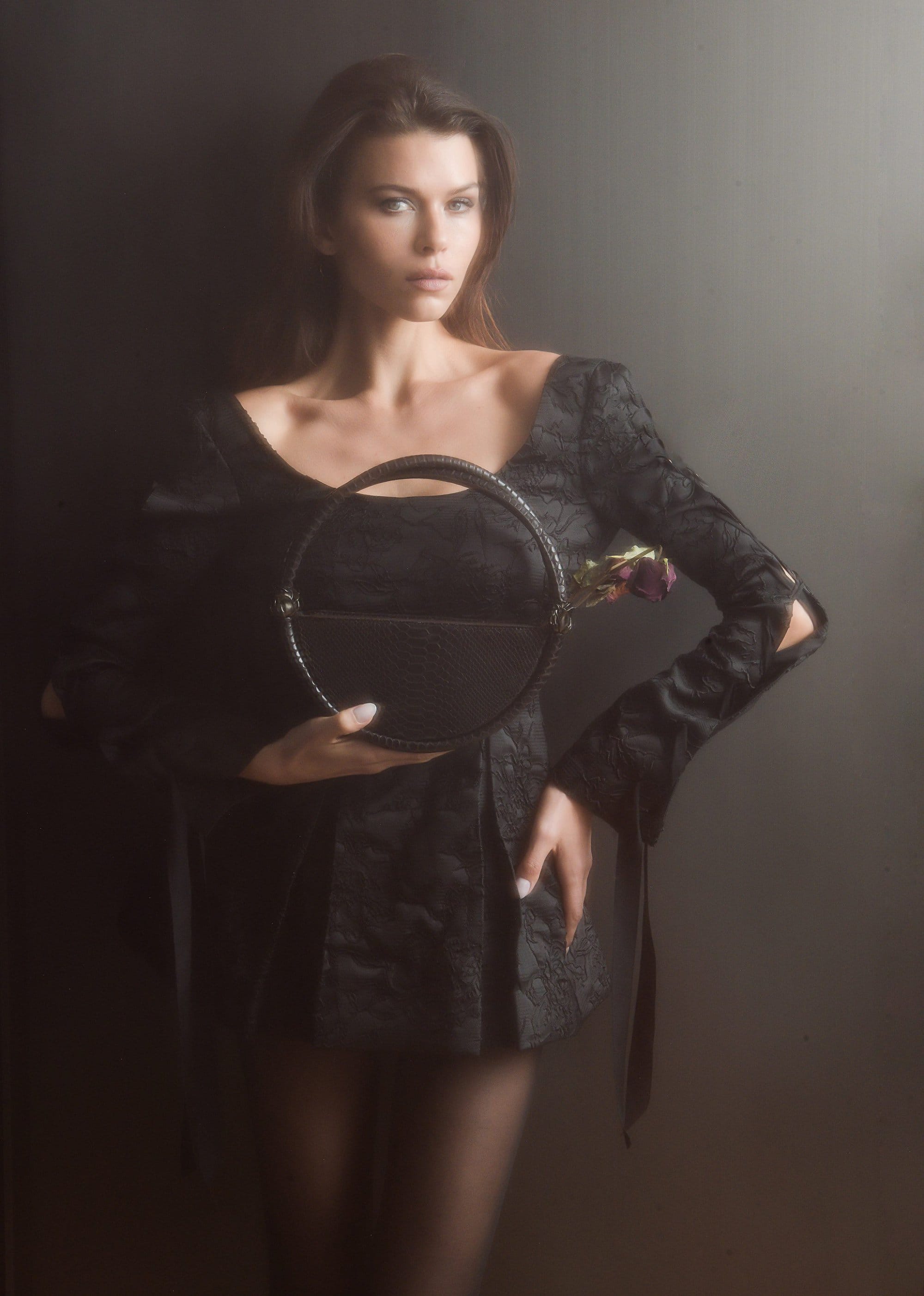 Model Georgia Fowler holding a round black handbag for Contessa Mills World Bag campaign photographed by Jacques Burga