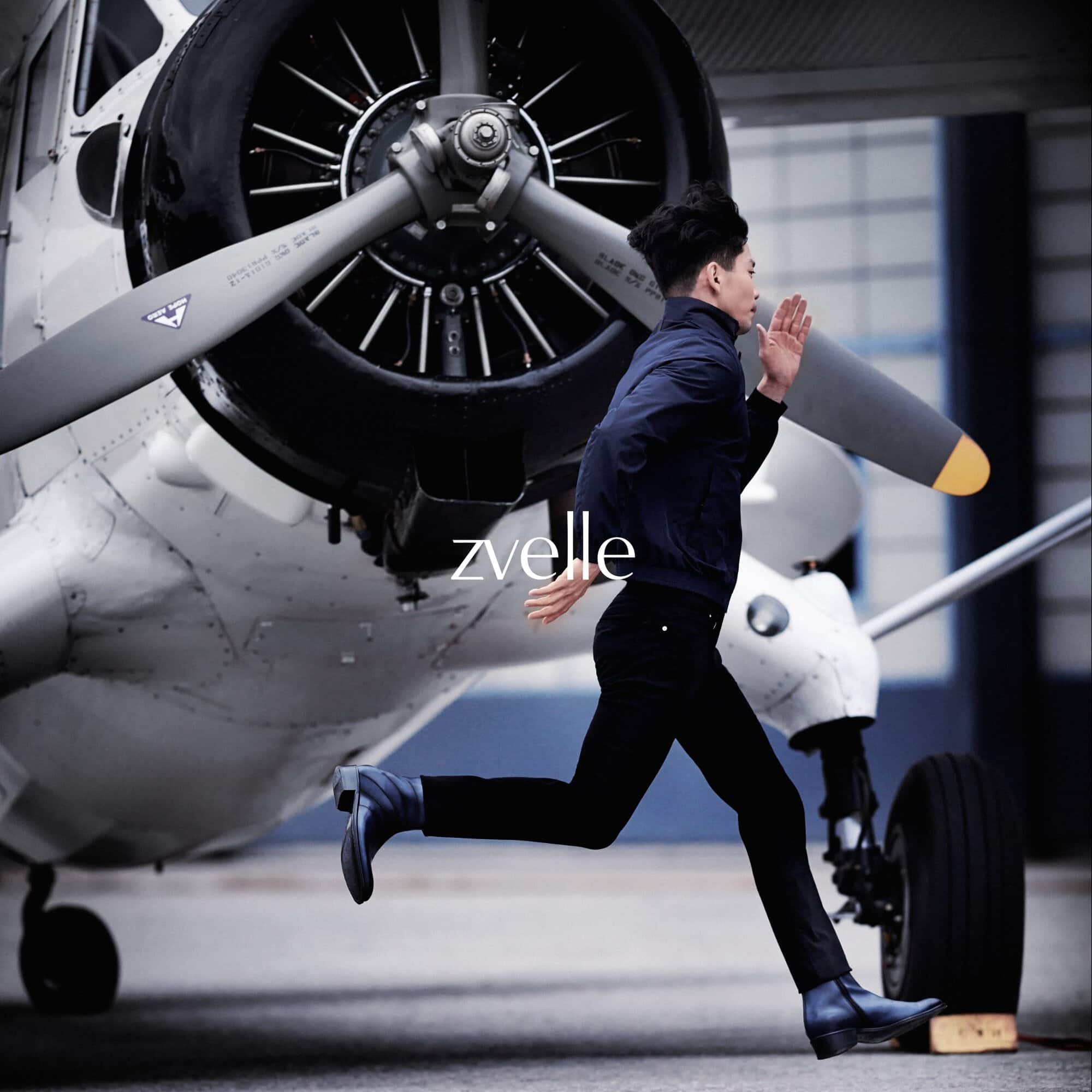 Man running past a large white airplane propeller in an ad campaign for Zvelle by photographer Daniel Harrison