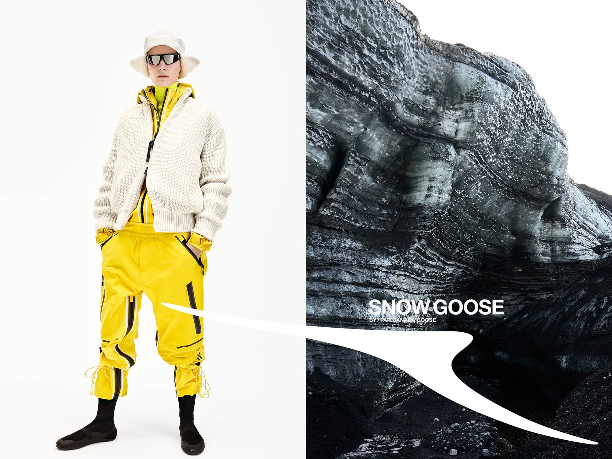 Model wearing a white bucket hat, sunglasses, white knit cardigan, and bright yellow outerwear trousers against a white background