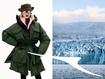 Model wearing a green parka, hat, and sunglasses against a snowy mountain landscape