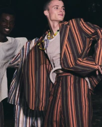 Two male models posing in striped garments outdoors at night for Zara Summer Aura, captured by Oliver Hadlee Pearch.