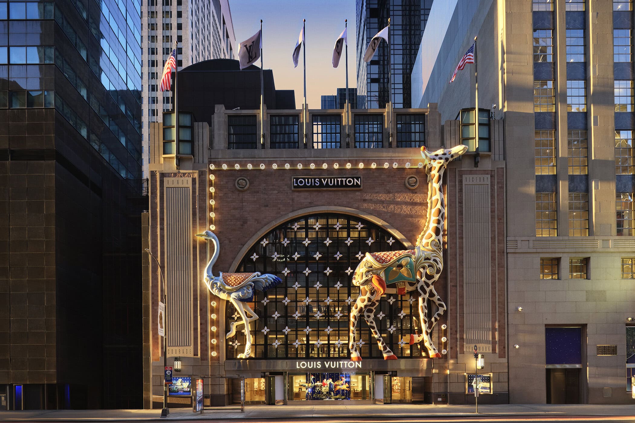 Louis Vuitton storefront decorated with large illuminated giraffe and ostrich sculptures for the Holiday 2024 campaign