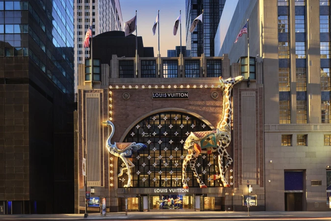 Louis Vuitton storefront decorated with large illuminated giraffe and ostrich sculptures for the Holiday 2024 campaign