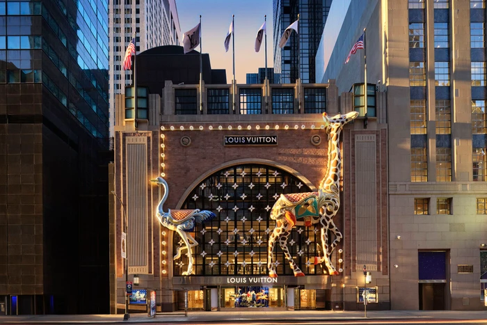 Louis Vuitton storefront decorated with large illuminated giraffe and ostrich sculptures for the Holiday 2024 campaign