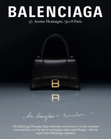 Balenciaga black leather Hourglass handbag on reflective grey gradient surface under studio lighting with brand text above and below.