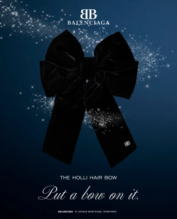 Large black velvet hair bow centered against a deep blue starry sky background with white branding text.