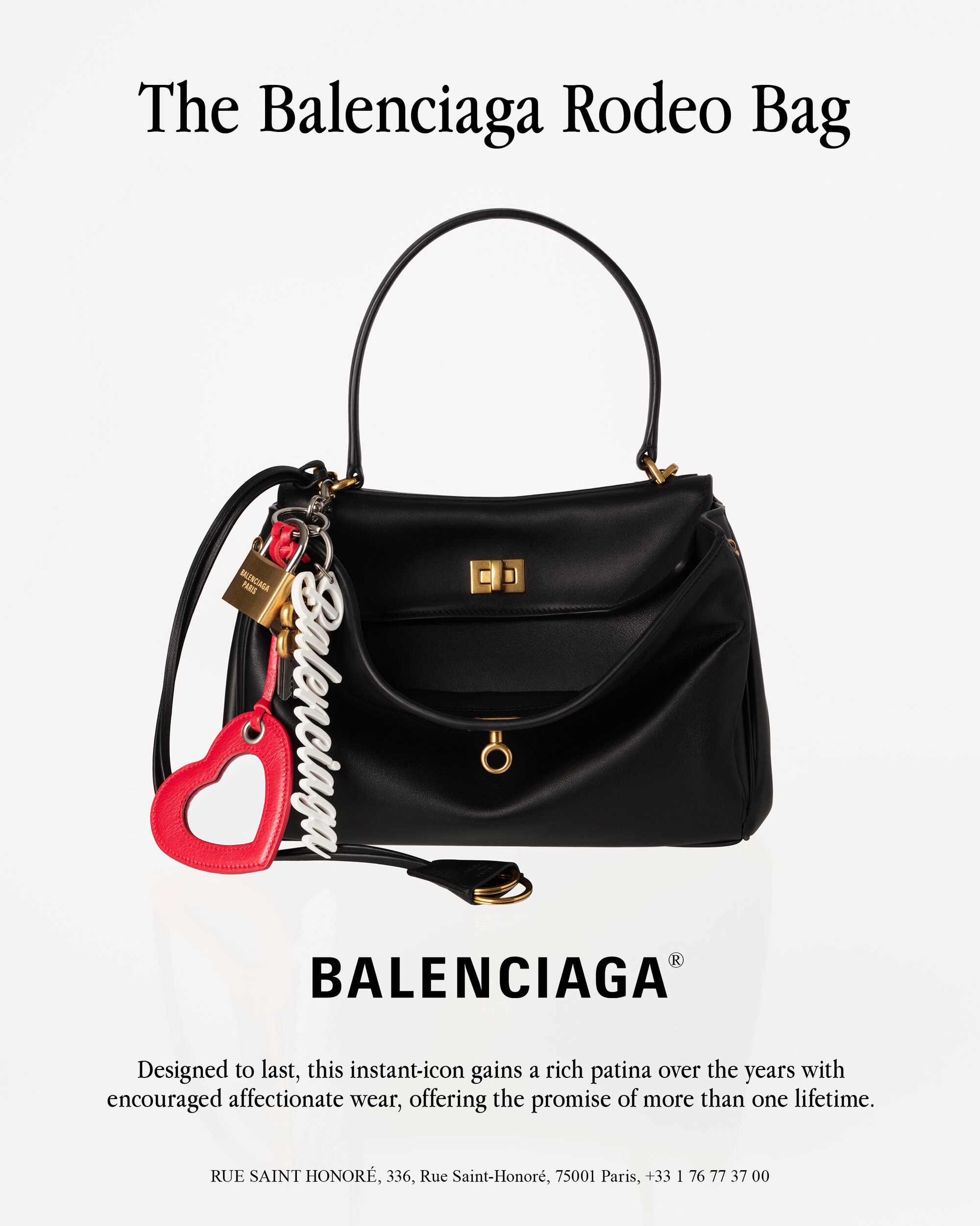 Balenciaga black leather Rodeo bag with charms and text on a white background