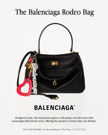 Balenciaga black leather Rodeo bag with charms and text on a white background
