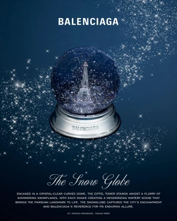 Balenciaga snow globe featuring the Eiffel Tower on a dark blue background with glittering stars and white text below.