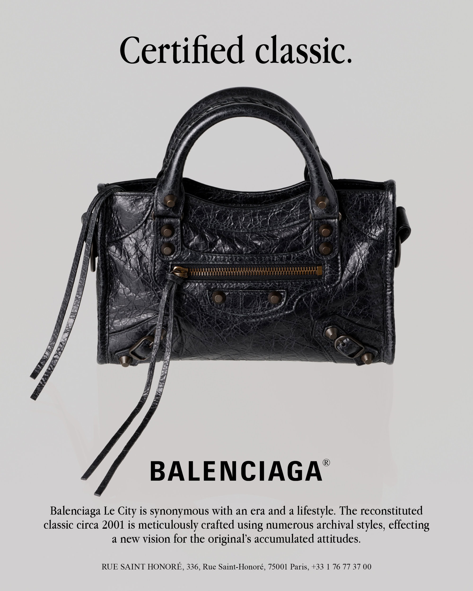 Black leather Balenciaga Le City handbag centered against a minimalist grey background with typography above and below