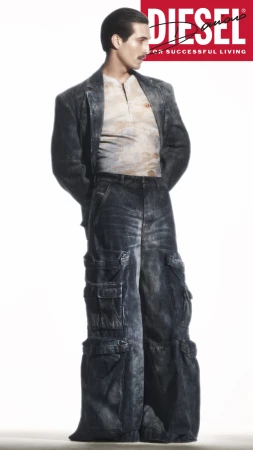 Damiano David wearing a distressed denim jacket and cargo pants against a white background for Diesel Fall 2024