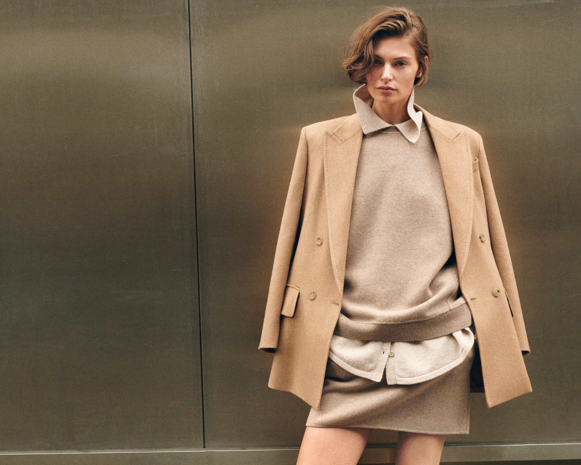 Model Bibi Breslin wearing a camel coat and matching skirt for the Max Mara Fall 2024 campaign, photographed by Oliver Hadlee Pearch.