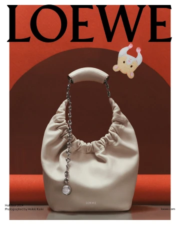 Off-white leather hobo handbag with chain strap displayed against a geometric arch backdrop for Loewe Holiday 2024 campaign