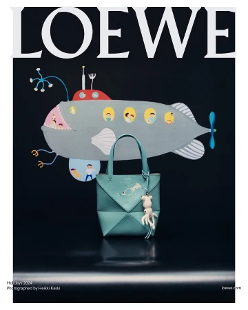 Turquoise leather handbag with whimsical charm displayed against dark background with submarine illustration and Loewe text