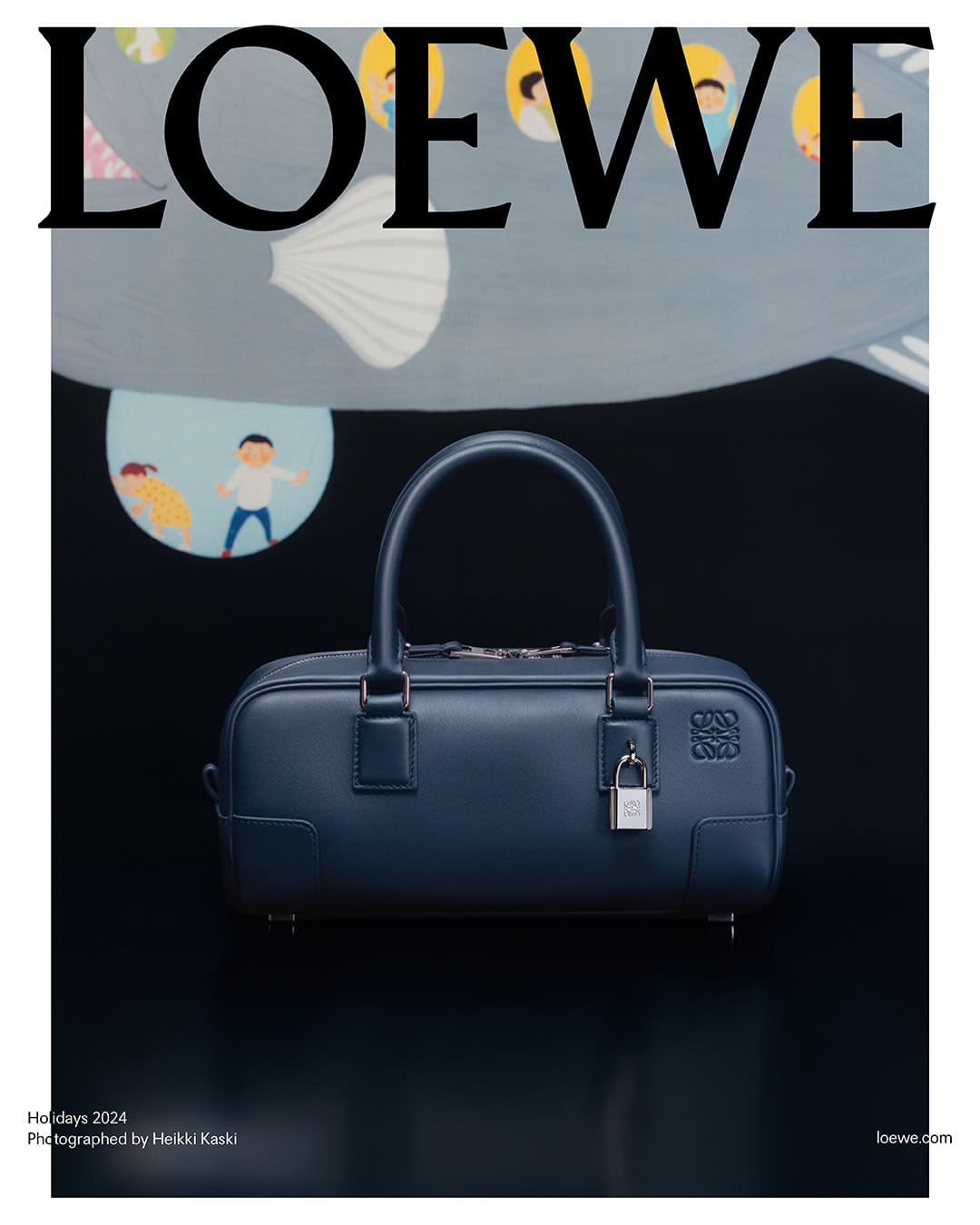 Loewe dark blue leather handbag centered against a dark surface under a painted illustrated backdrop