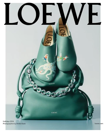 Loewe green leather shoes resting atop a matching green leather handbag with a silver chain strap against a grey background.