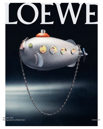 Metallic silver submarine-shaped handbag with portholes and a chain strap against a dark background for Loewe