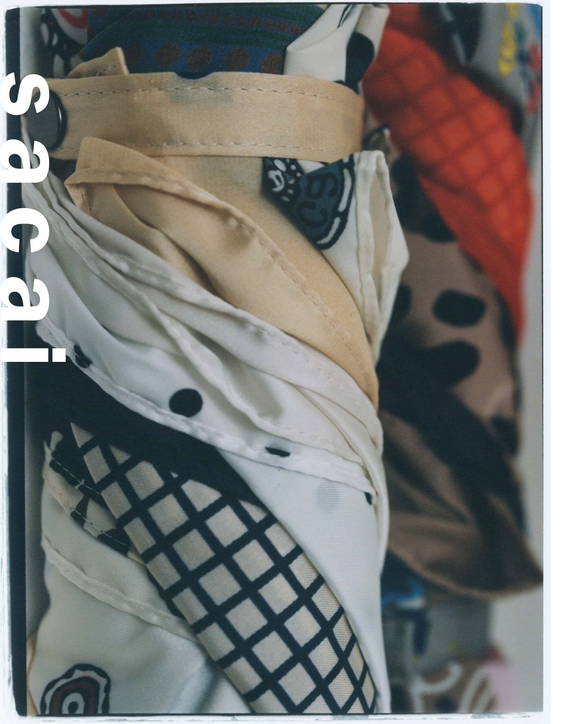 Close-up shot of rolled patterned fabric with visible text reading sacai along the edge