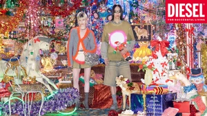 Two models standing in front of a heavily decorated festive room filled with tinsel, toys, and holiday ornaments for Diesel.