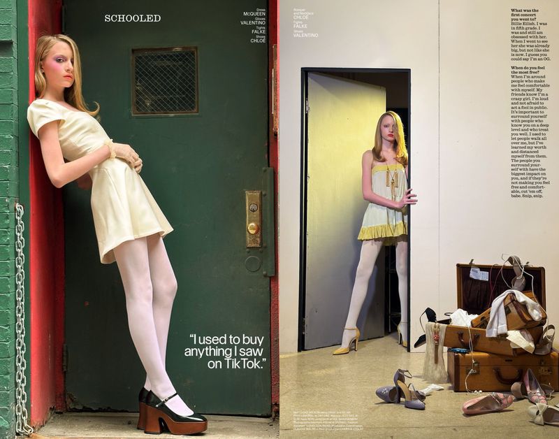 Fashion editorial: A fair-skinned blonde woman in a cream dress and Mary Janes leans against a green door and red wall in a two-page spread.
