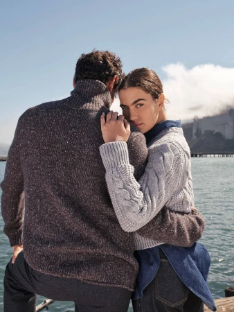 Man and woman embracing near water wearing textured knit sweaters for Banana Republic