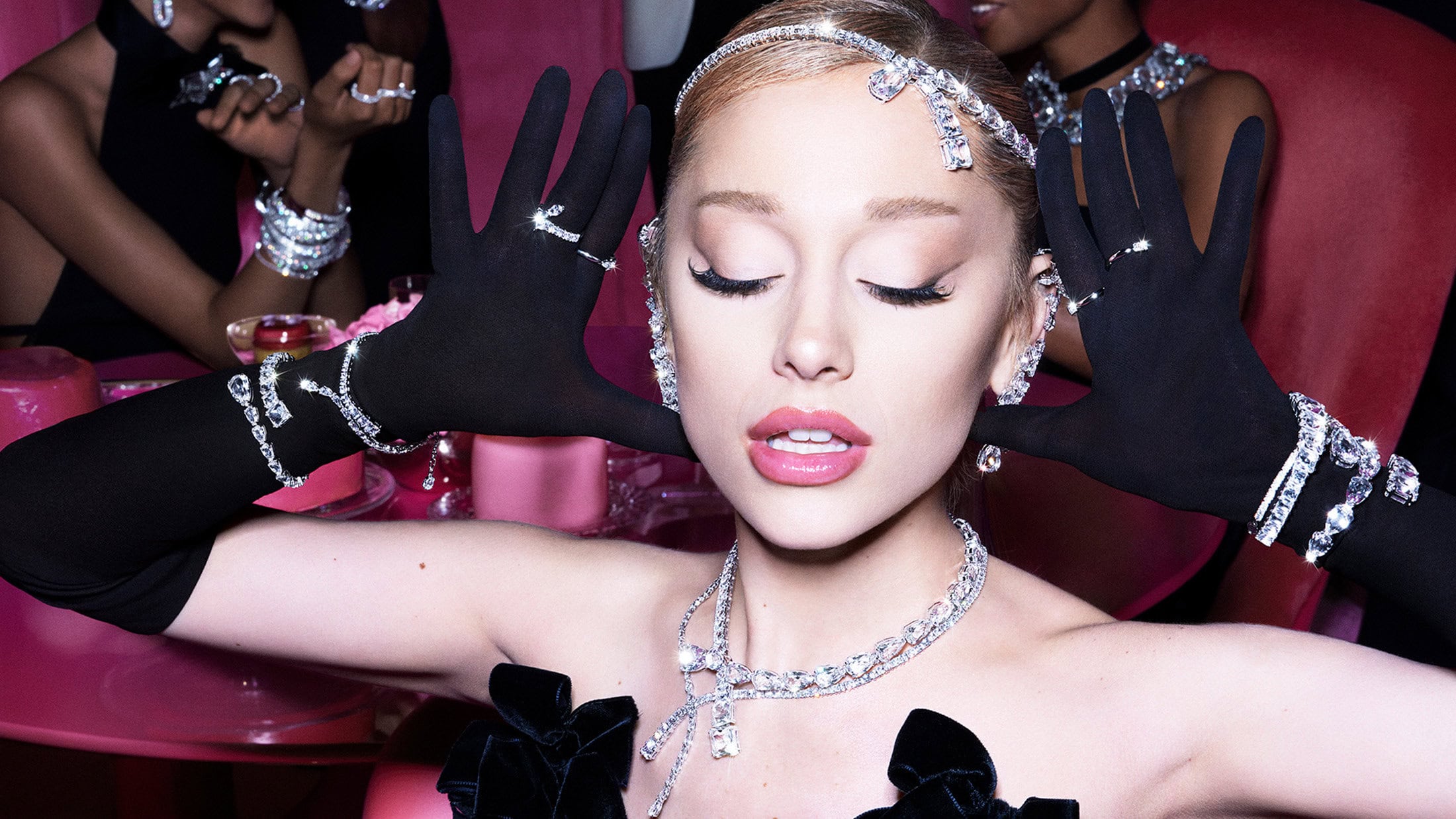 Ariana Grande wearing sparkling crystal jewelry and black gloves in the Swarovski Party Of Dreams Holiday campaign