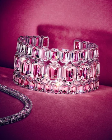 Crystal cuff bracelet and matching necklace against a rich pink velvet background