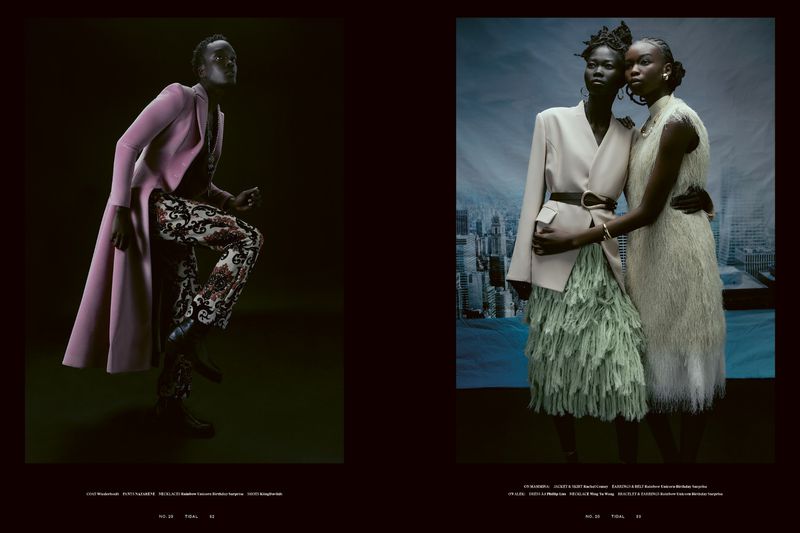 Two African women in a fashion editorial pose in a studio setting with patterned clothing, overcoats, and a city background, exuding elegance.