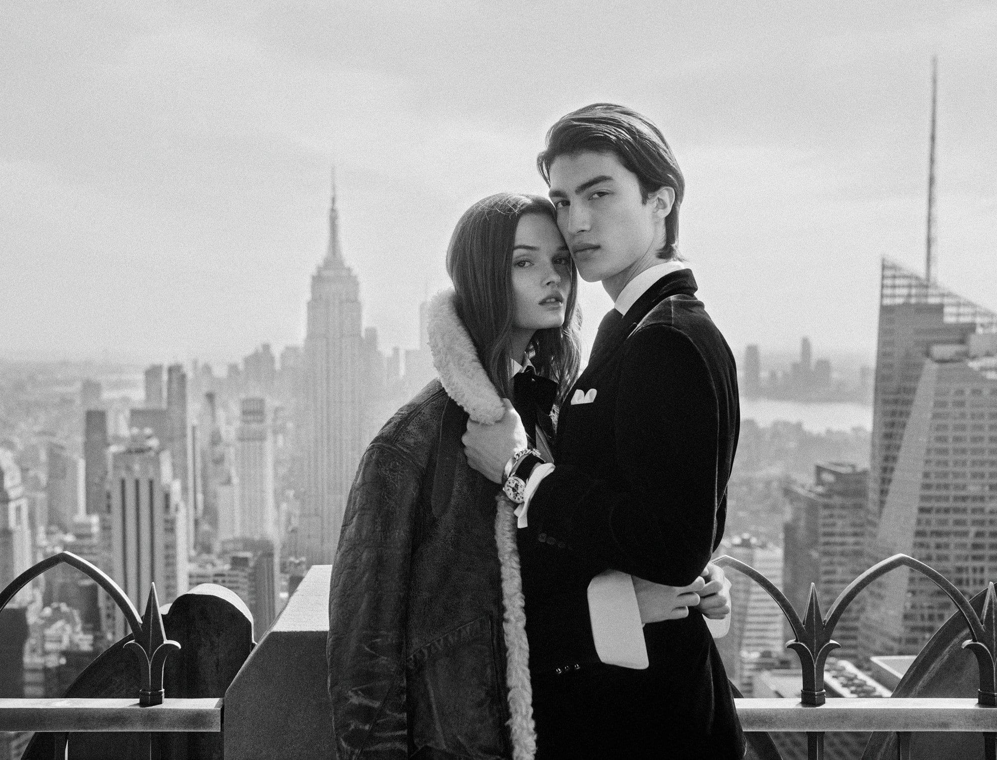 Monochrome rooftop portrait of a man and woman in formal attire against the New York City skyline for Ralph Lauren.