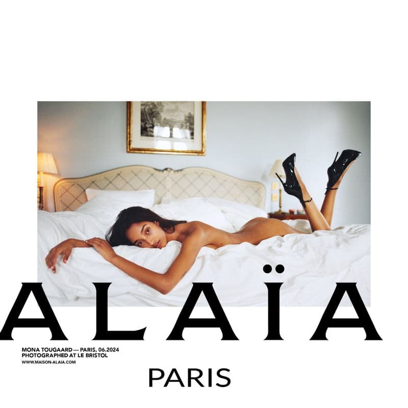 Model Mona Tougaard resting on a white bed wearing high heels for an Alaïa ad campaign photographed by Tyrone Lebon.