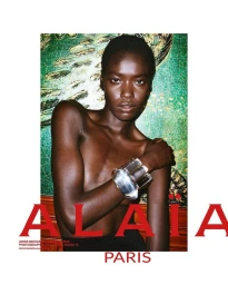 Black woman wearing a clear sculptural bracelet against a green patterned background for Alaia fall 2024 ad campaign