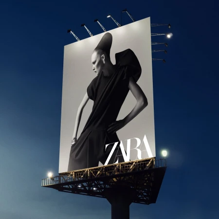 A large outdoor advertising billboard at dusk displaying a high-contrast black and white fashion portrait for Zara with structural apparel.