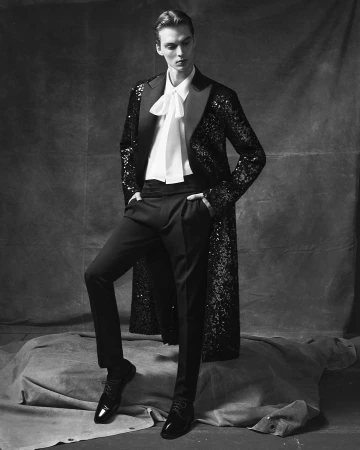 Model Leon Dame in sequined coat and bow blouse posing for Dolce & Gabbana campaign