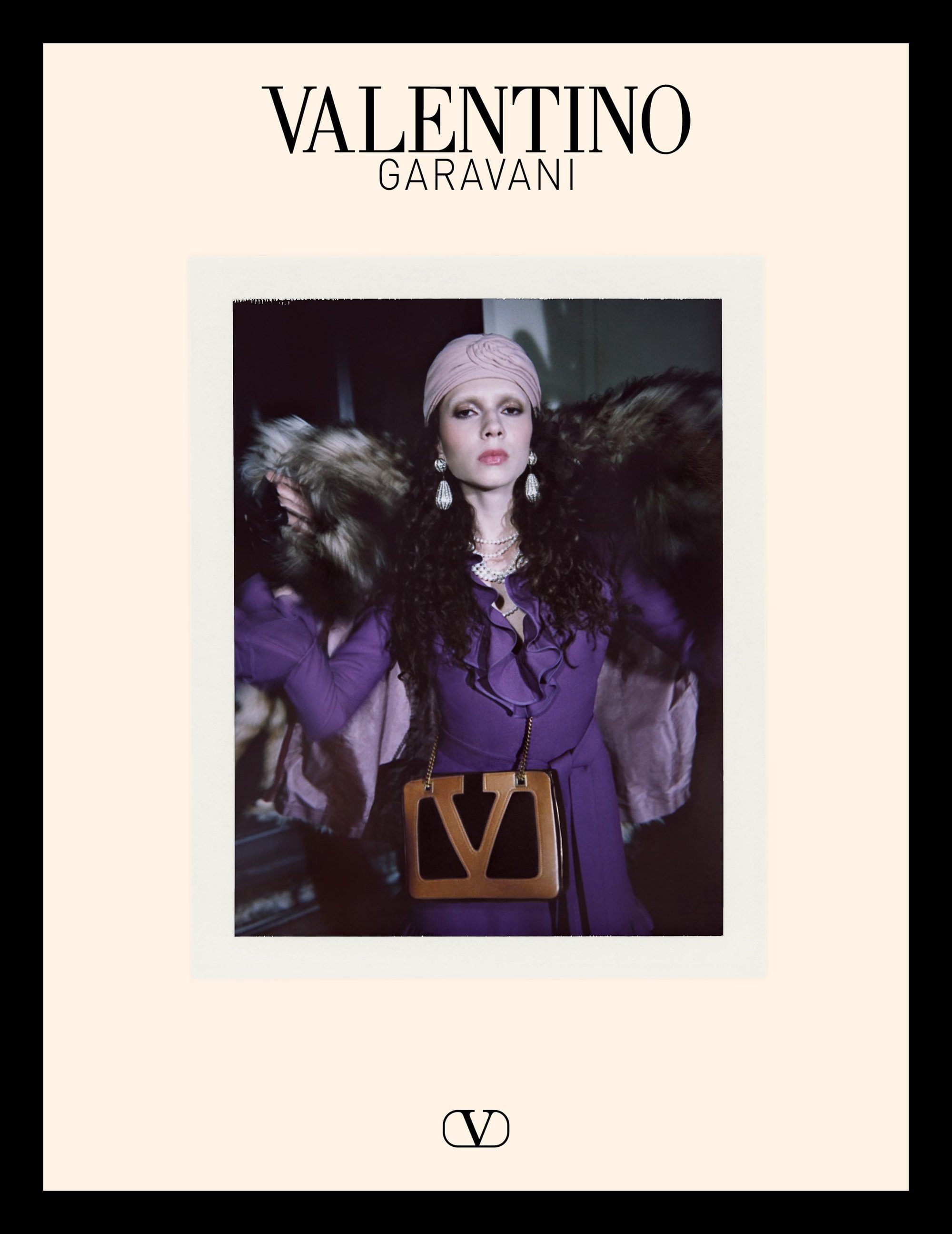 Model in purple dress with fur coat and tan handbag for Valentino Avant les Débuts campaign