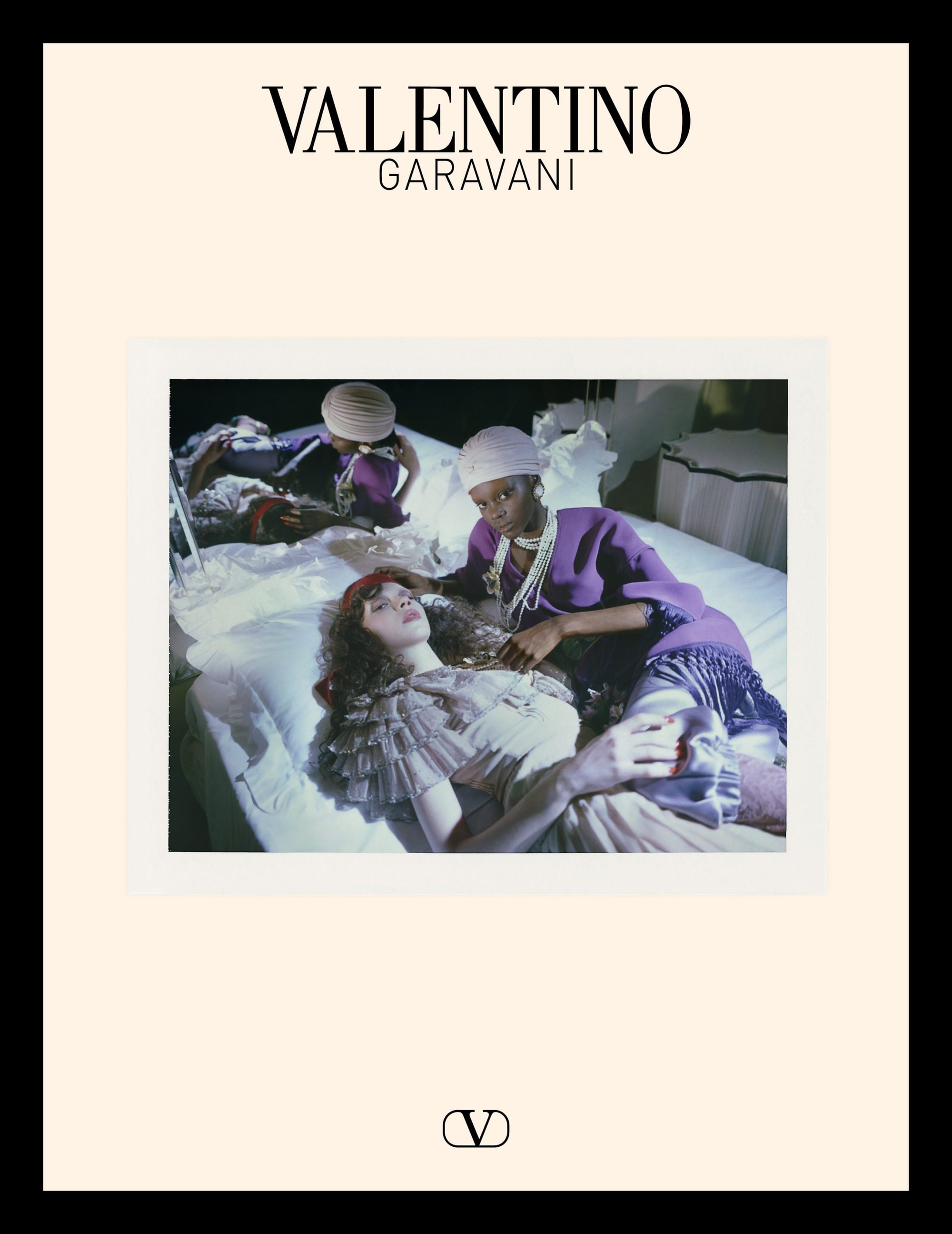 Valentino Garavani ad campaign featuring models on a bed in a bedroom setting for Avant les Débuts Resort 2025.