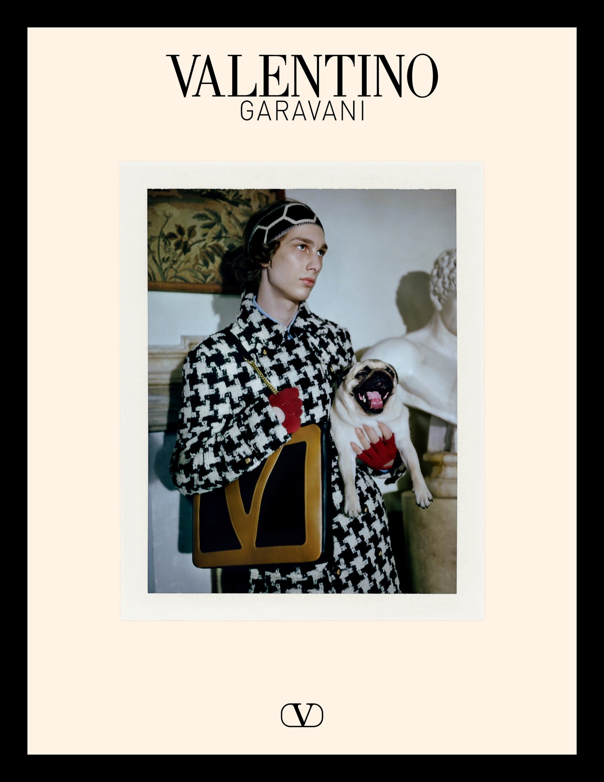 Model in houndstooth coat holding a pug and handbag for Valentino Avant les Debuts campaign