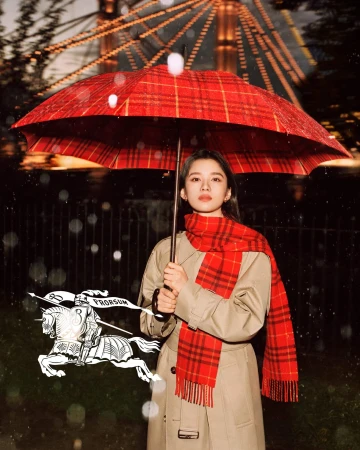 Zhang Jingyi holding a red plaid umbrella and wearing a trench coat for Burberry It's Always Burberry Weather campaign