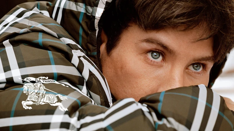 Close-up portrait of Cole Palmer wearing a dark plaid hooded puffer jacket from Burberry's 2024 campaign