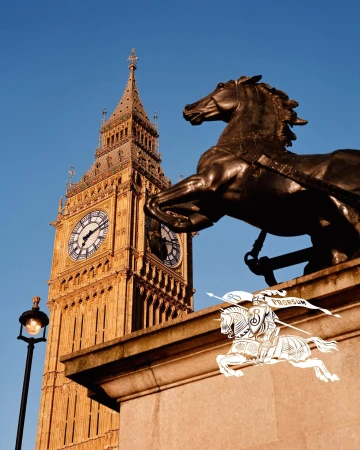 Bronze horse statue in foreground against the Elizabeth Tower and clear blue sky for Burberry campaign