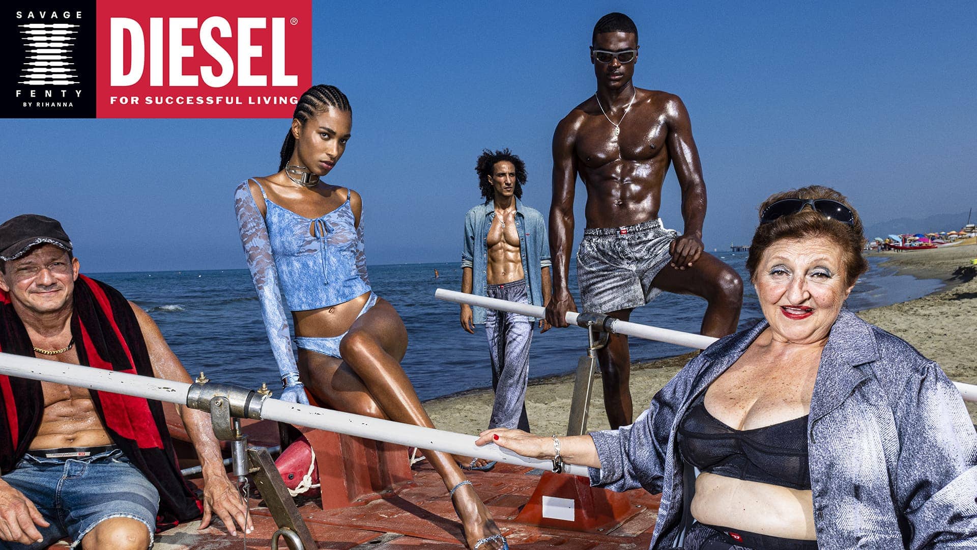 Diverse group of models posing on a beach platform against an ocean backdrop for Diesel x Savage X Fenty campaign