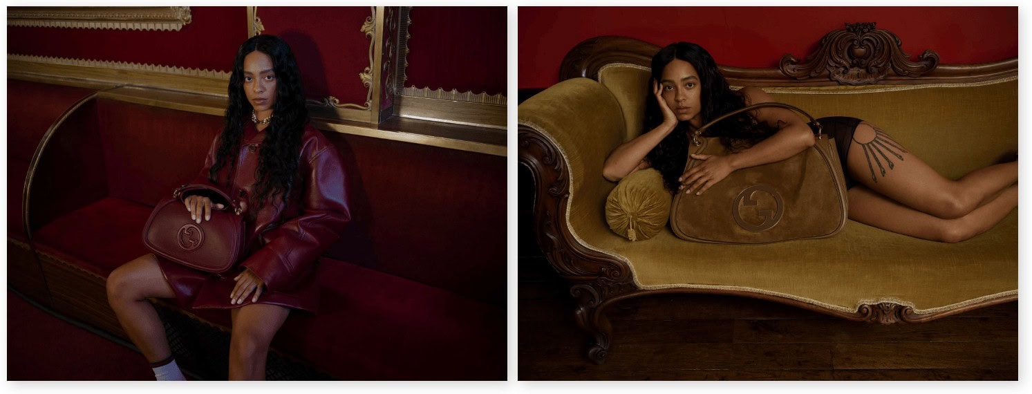Model holding a burgundy leather handbag sitting on a red velvet banquette next to another reclining on a green velvet sofa