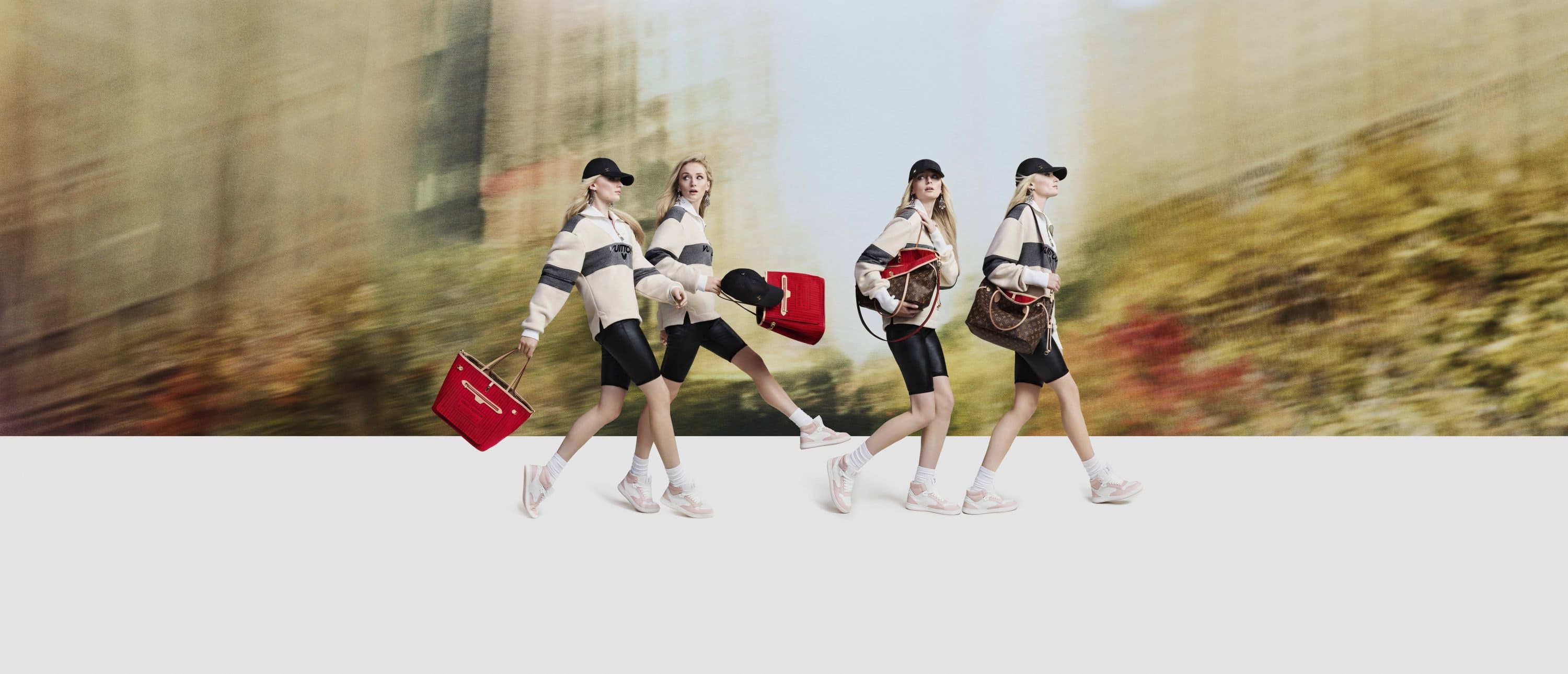 Sophie Turner in Louis Vuitton campaign walking across a studio floor against a blurred motion background