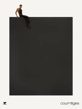 Model sitting on the edge of a large dark block against a white background for Courrèges Fall 2024 campaign