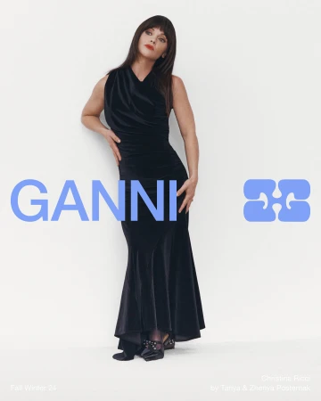 Christina Ricci in a black velvet dress standing against a plain white background for Ganni Fall 2024 ad campaign
