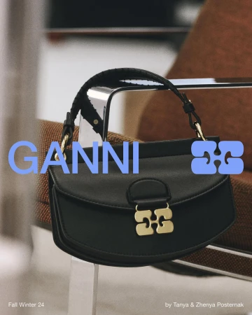 Black leather shoulder bag with gold hardware resting on a chair for Ganni Fall 2024 ad campaign