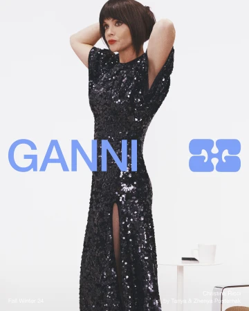 Christina Ricci in a black sequin dress with her hands behind her head against a white background for Ganni Fall 2024 ad campaign.