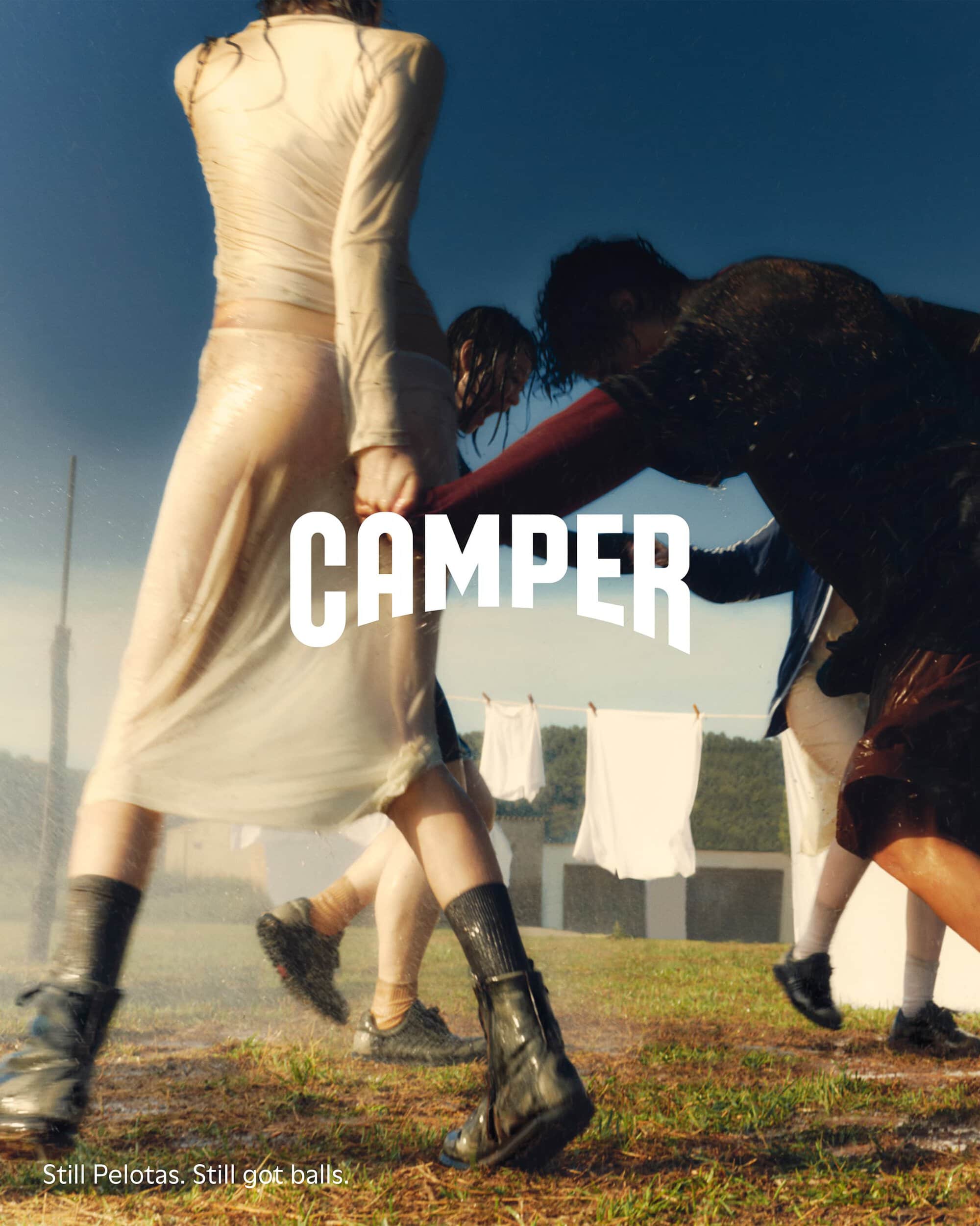 Group of models standing on a grassy field outdoors with hanging laundry in the background for Camper Fall 2024 ad campaign
