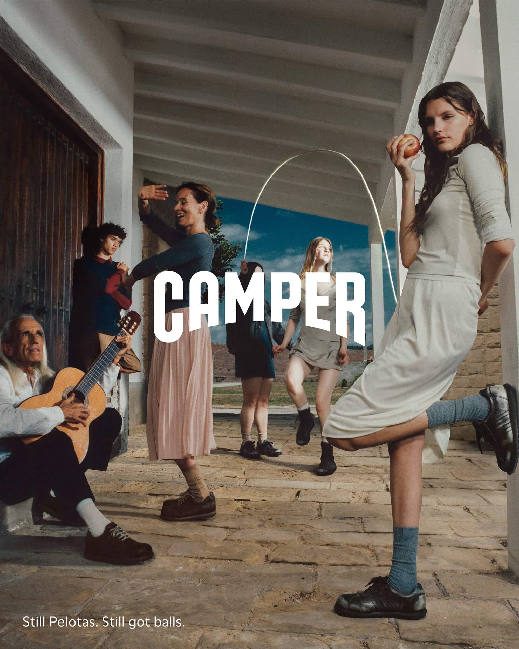 Group of people posing outdoors on stone paving under a portico for Camper Fall 2024 ad campaign