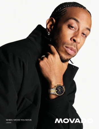 Close-up portrait of Ludacris wearing a black jacket and a luxury watch against a clean white background for Movado fall campaign.